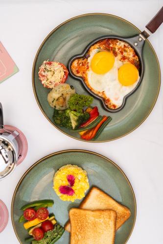 two plates of breakfast food with eggs and toast at Padmaa Jaipur in Jaipur