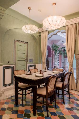 a dining room with a table and chairs at Padmaa Jaipur in Jaipur