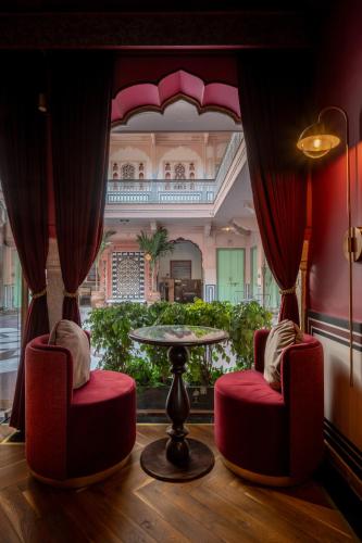 a room with two chairs and a table in a building at Padmaa Jaipur in Jaipur