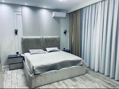 a bedroom with a bed and a large window at Süvalan in Baku