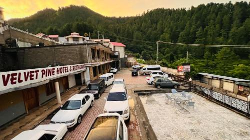 a bunch of cars parked in a parking lot at Velvet Pine Hotel in Abbottābād