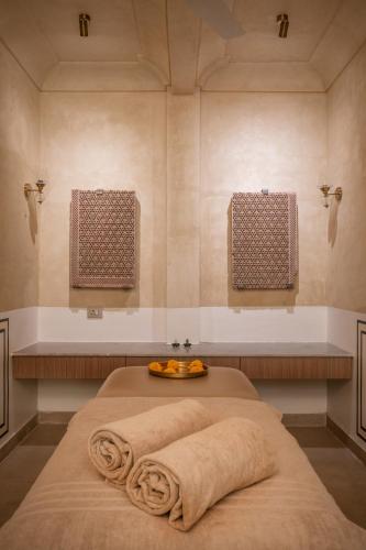 a room with a bed with a bowl of fruit on it at Padmaa Jaipur in Jaipur