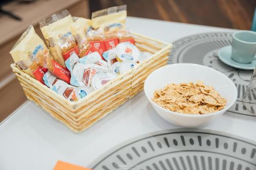 a basket of snacks and a bowl of cereal on a table at Vicolo72 in Calitri