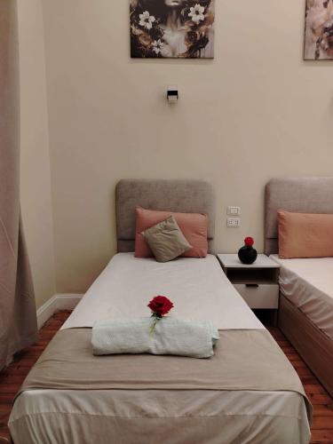 a bedroom with a bed with a rose on it at Tahrir Palace in Cairo