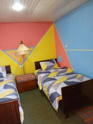 Una cama o camas en una habitación de Rossi Rest House