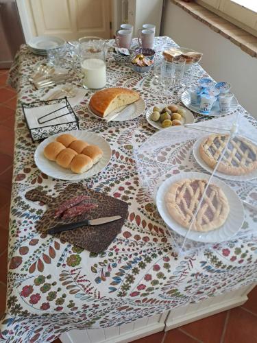 a table with plates of food on top of it at La Casa dei Cavalli B&B Narni in Narni