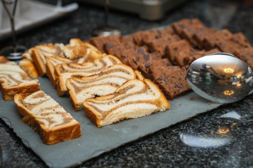 a bunch of bread on a table with a spoon at Belvédère Strandhotel in Spiez