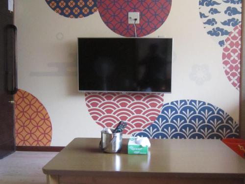 a room with a table with a tv on a wall at Numazu - House - Vacation STAY 59955v in Numazu