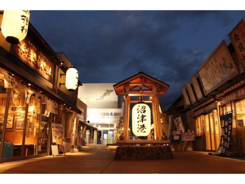 a clock in the middle of a street at night at Numazu - House - Vacation STAY 59955v in Numazu