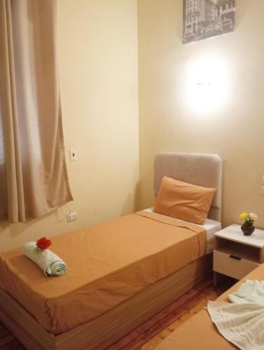 a small bedroom with a bed and a window at Tahrir Palace in Cairo