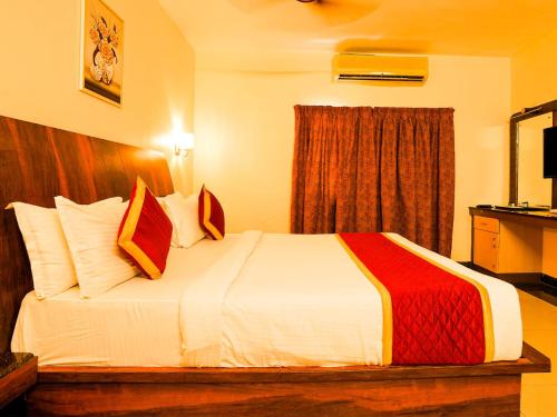 a hotel room with a large bed in a room at Eastin Park in Navalur