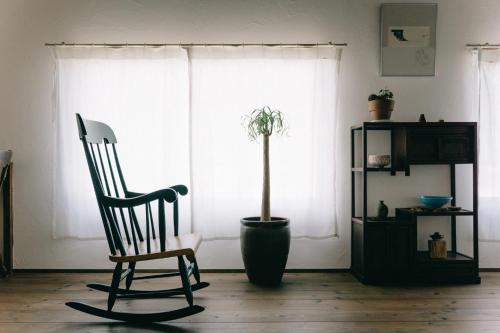 a chair and a potted plant in a living room at Hotaru no Yado - Vacation STAY 68063v in Fukuyama