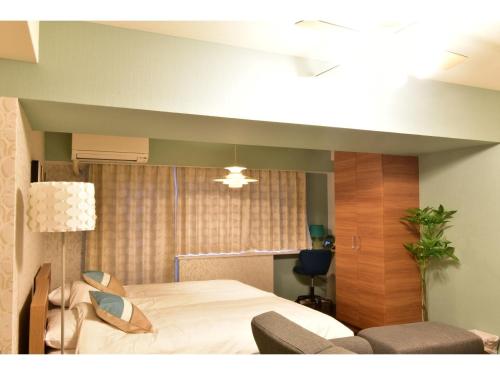 Giường trong phòng chung tại Alphabed Takamatsu Furujinmachi - Vacation STAY 11904