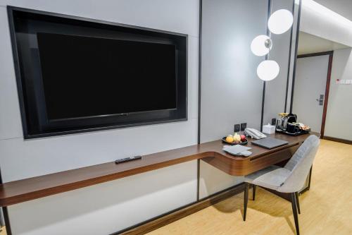 a living room with a large flat screen tv on a wall at Yello Hotel Samarinda in Samarinda