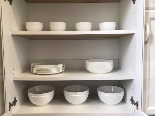 a cabinet filled with white bowls and plates at Oase Nosoko - Vacation STAY 69732v in Ibaruma