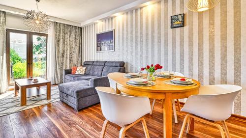 a living room with a table and a couch at Resort Sudety, Sun & Snow in Szklarska Poręba