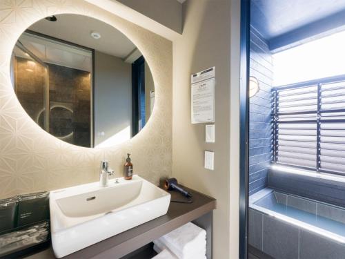 a bathroom with a sink and a mirror at Rakuten STAY Nikko Hoden No pets allowed Capacity of 6 persons in Nikko
