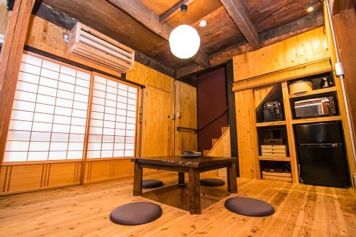 a kitchen with a table in a room with wooden walls at Machiya Villa Seian - Vacation STAY 11749 in Fukuoka