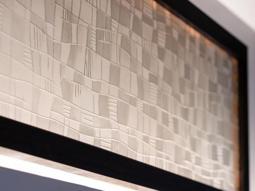 a picture of a wall with brown and white tiles at Takayanagi Ryokan - Vacation STAY 88528v in Takamatsu