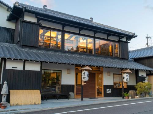a building with large windows on a street at Takayanagi Ryokan - Vacation STAY 88528v in Takamatsu