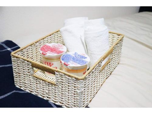 a basket filled with toiletries sitting on a bed at OHANA TOKYO HOUSE - Vacation STAY 73657v in Tokyo