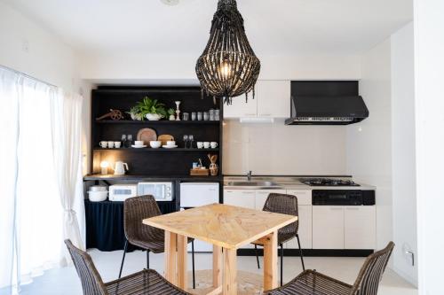 a kitchen with a wooden table and chairs at Vent du Vent 402 - Vacation STAY 83691v in Urasoe