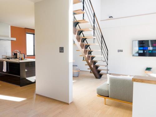 a living room and kitchen with a spiral staircase at Rakuten STAY Fuji Kawaguchiko Station - Japanese Modern Villa Mt Fuji View 105 in Fujikawaguchiko