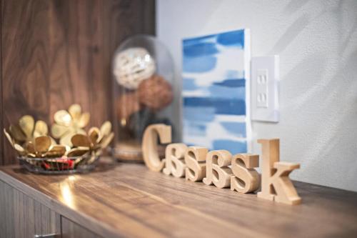 a wooden word senses sitting on a shelf with a clock at CASAS-K NISHIKUJYO - Vacation STAY 12157 in Osaka