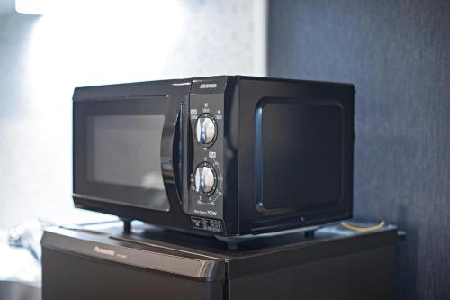 a television sitting on top of a cabinet at CASAS-K NISHIKUJYO - Vacation STAY 12157 in Osaka