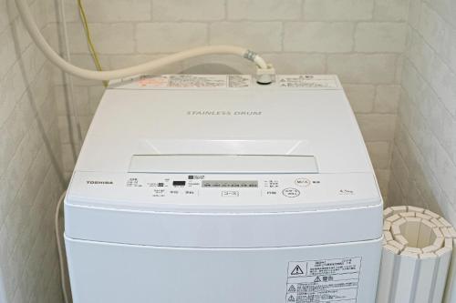a washer and dryer in a laundry room at CASAS-K NISHIKUJYO - Vacation STAY 12157 in Osaka