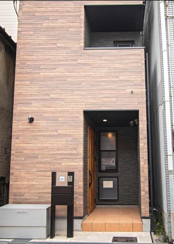 a building with a sign in front of a door at CASAS-K NISHIKUJYO - Vacation STAY 12157 in Osaka