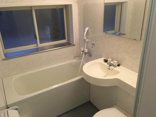 a bathroom with a sink and a tub and a toilet at SEE-GOT-LIKE-Sansou - Vacation STAY 87979v in Tsumagoi