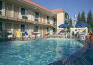 a large swimming pool in front of a hotel at Vagabond Inn Fresno in Fresno