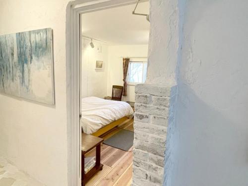 a room with a stone fireplace and a bedroom at Gallery HARA & GUESTHOUSE - Vacation STAY 95372v in Hara