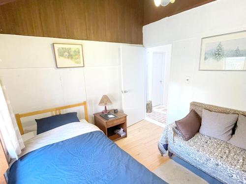 a bedroom with a bed and a chair in it at Gallery HARA & GUESTHOUSE - Vacation STAY 90971v in Hara