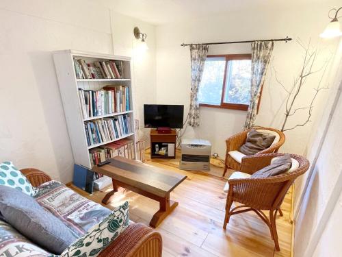 a living room with a couch and a table at Gallery HARA & GUESTHOUSE - Vacation STAY 90971v in Hara