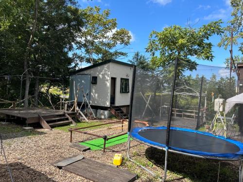 a tiny house with a trampoline in the yard at niseko kamahale village - Vacation STAY 91397v in Ōmagari