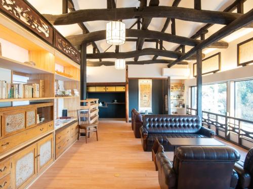 a large room with leather chairs and a library at Takayanagi Ryokan - Vacation STAY 88522v in Takamatsu