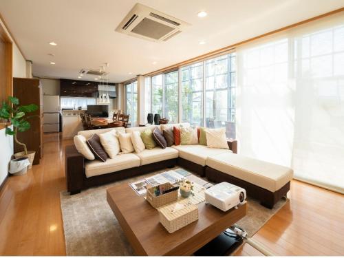 a living room with a couch and a table at Palm Villa - Vacation STAY 12202 in Takamatsu