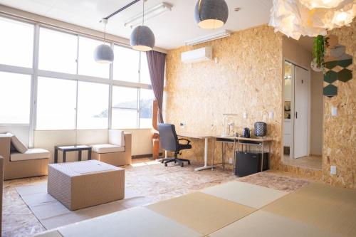 an office with a desk and a chair in a room with windows at Agri Museum NADA - Vacation STAY 40517v in Minamiawaji