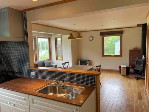 a kitchen with a sink and a living room at Farm Inn Torch B - Vacation STAY 92724v in Tsurui