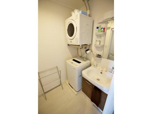 a bathroom with a sink and a washing machine at Vent du Vent - Vacation STAY 83347v in Urasoe