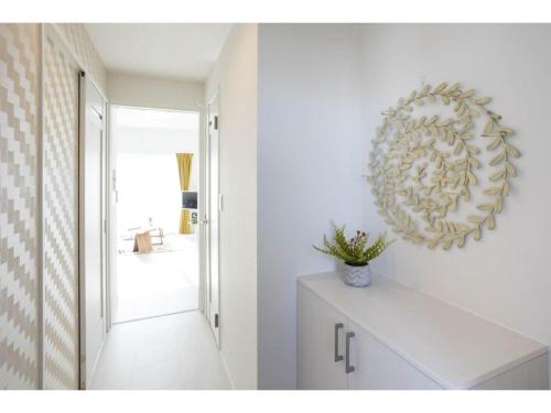 a white room with a mirror on the wall at Vent du Vent 5F - Vacation STAY 83698v in Urasoe
