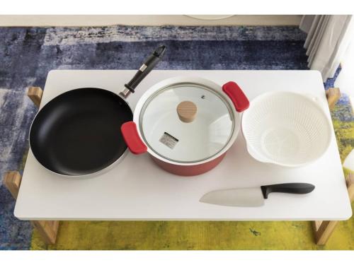 a white table with a pot and a spatula at Vent du Vent 5F - Vacation STAY 83698v in Urasoe