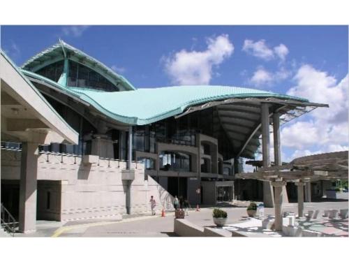a large building with a green roof on top of it at Vent du Vent 5F - Vacation STAY 83698v in Urasoe