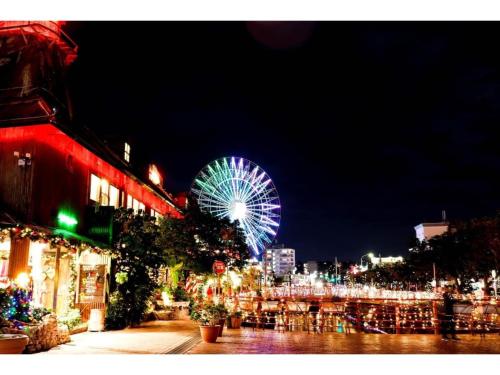 a ferris wheel in a city at night at Vent du Vent 5F - Vacation STAY 83698v in Urasoe