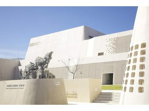a building with a statue in front of it at Vent du Vent 5F - Vacation STAY 83698v in Urasoe