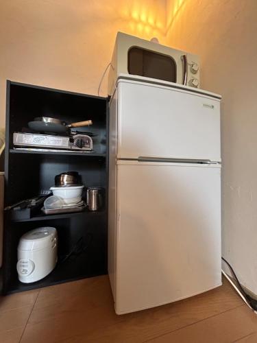 a refrigerator with a microwave on top of it at niseko kamahale village - Vacation STAY 85808v in Kaributo