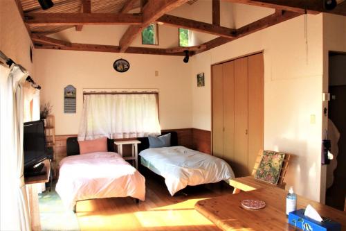 a living room with two beds and a tv at Dekoichi - Vacation STAY 96103v in Setouchi
