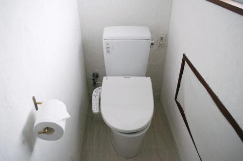 a bathroom with a toilet and a roll of toilet paper at Guest house LOOP - Vacation STAY 06208v in Kobayashi